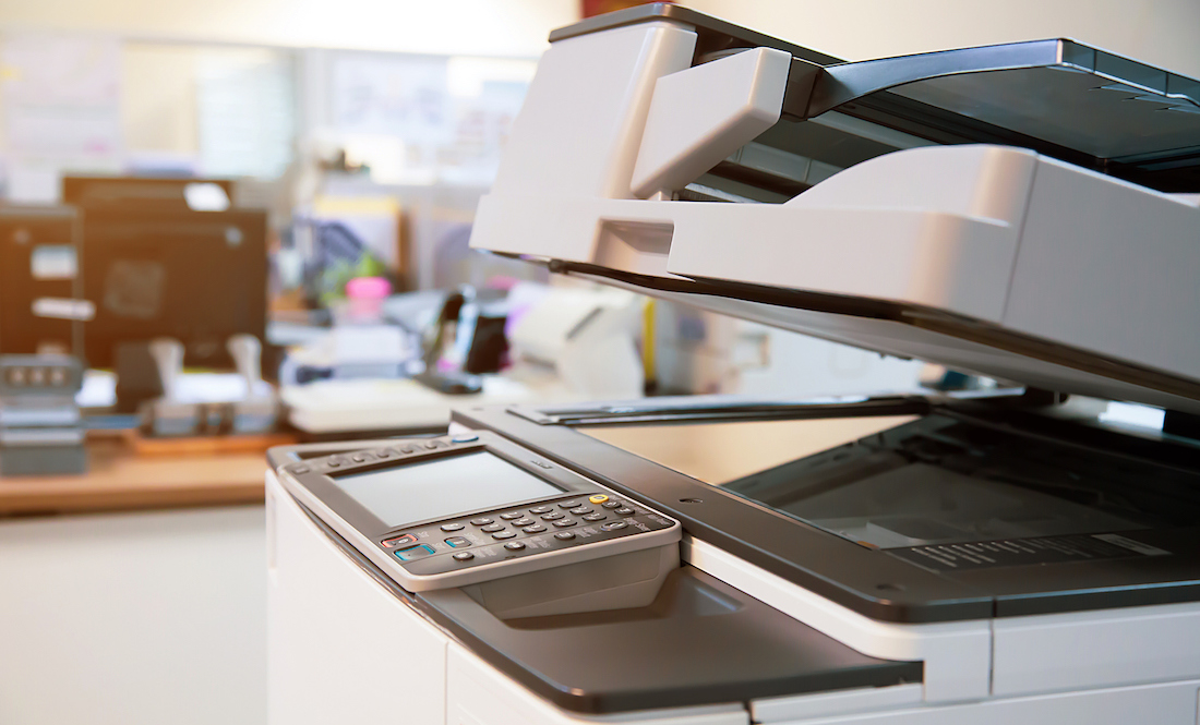 Close-up photocopier or printer is office worker tool equipment for scanning and copy paper.