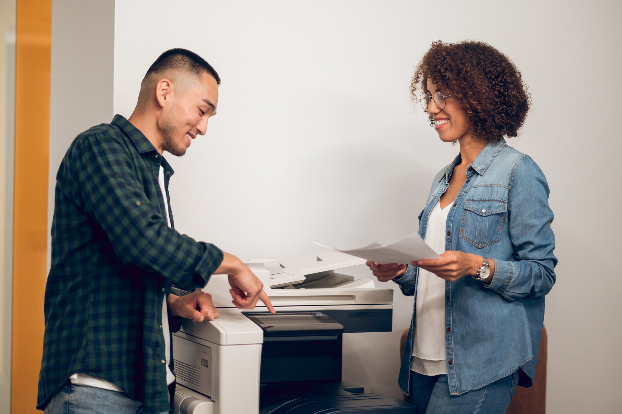 Two colleagues at an office copier