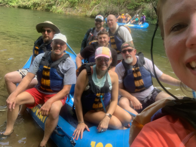 A quick selfie of eight of our Charlotte team members in the water on a rafting trip. They're having a blast!