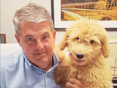 Charlotte Regional Sales Manager, Tom Skeels, poses with his adorable puppy.